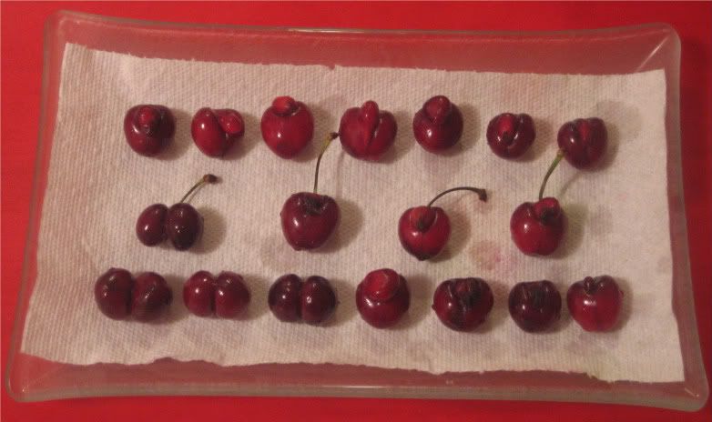 rectangular glass tray with deformed cherries arrayed on top