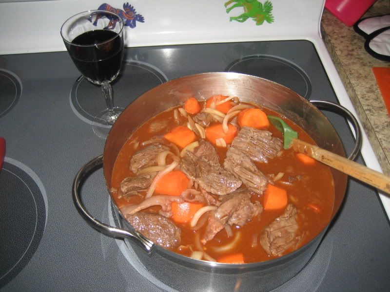 pot of uncooked stew and glass of wine