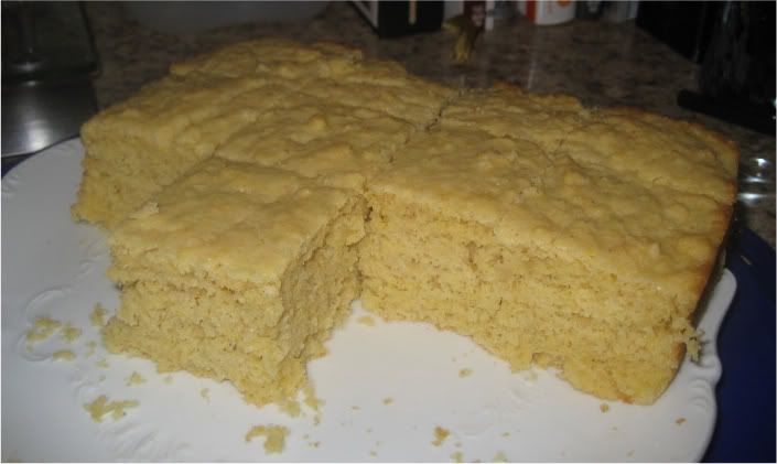 half pan of cornbread cut into squares on white plate
