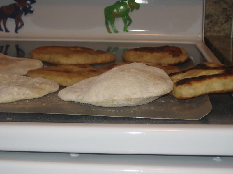 side view pita showing white baked puffed pitas and yellow-brown unpuffed fried pitas