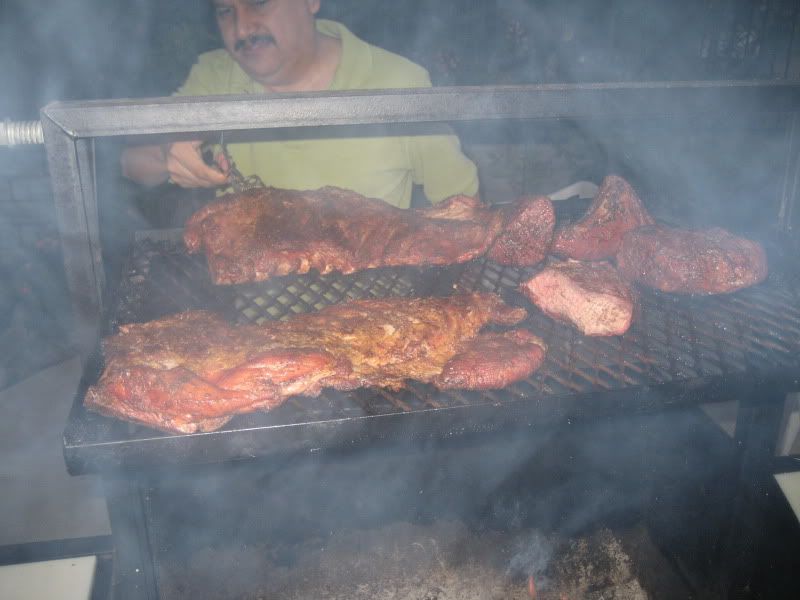 smoky grill with racks of ribs and tri-tip