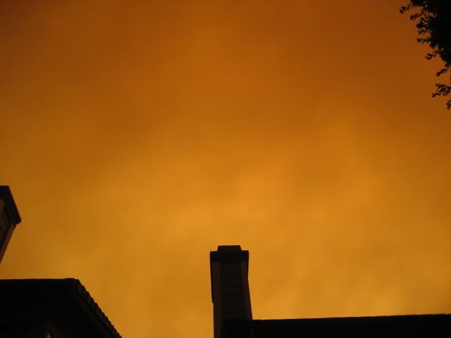 overhead air, dropping ash, dark and orange from smoke