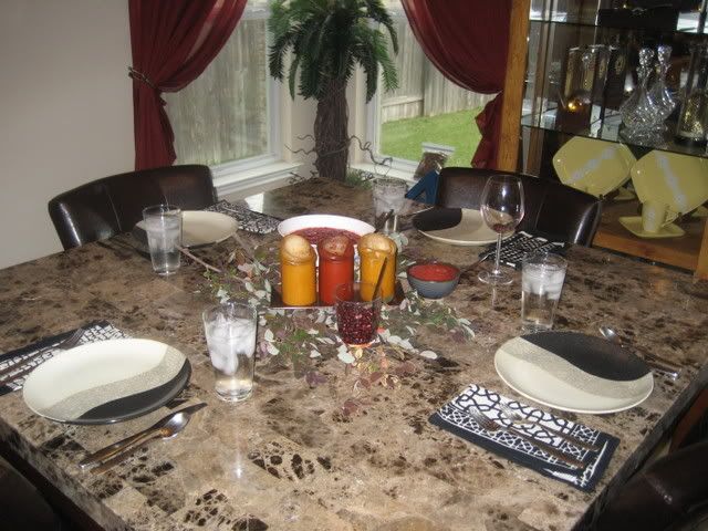 counter height marble table with centerpiece and pomegranate