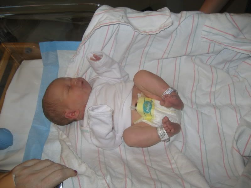 baby with tiny toes on changing table