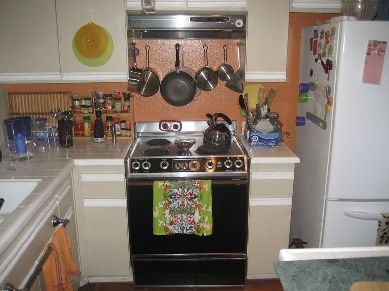 old black and brown stove in place with fridge