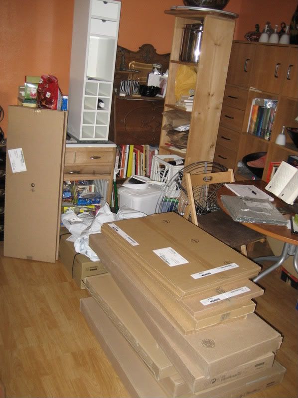 stack of flat pack boxes of cabinets on the floor