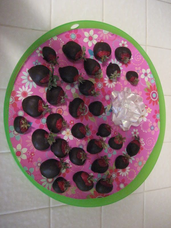 chocolate covered strawberries on new green Ikea tray with flowered paper and shadow of my arm obscuring the shot