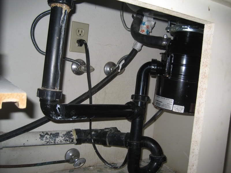 jumble of plumbing under the sink