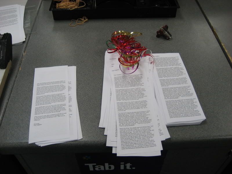 strips of paper with text, some with ribbons
