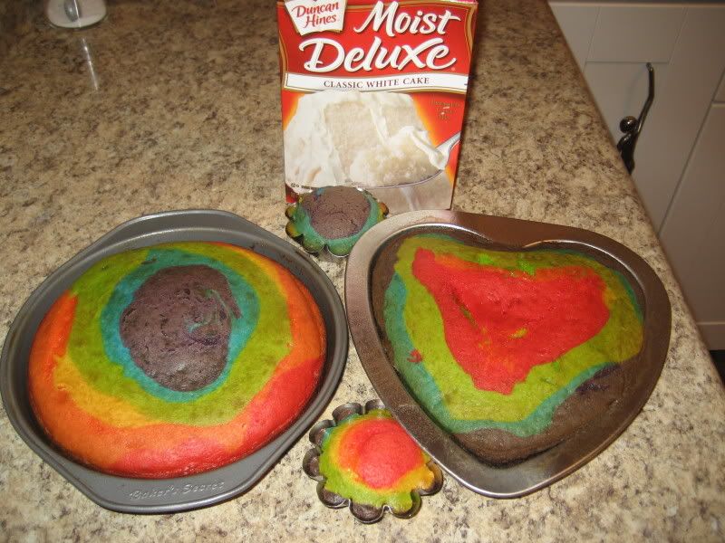 Rainbow Cake with some brown on top, one heart shaped