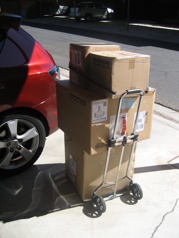 boxes stacked on foldable dolly next to my Mazda 3