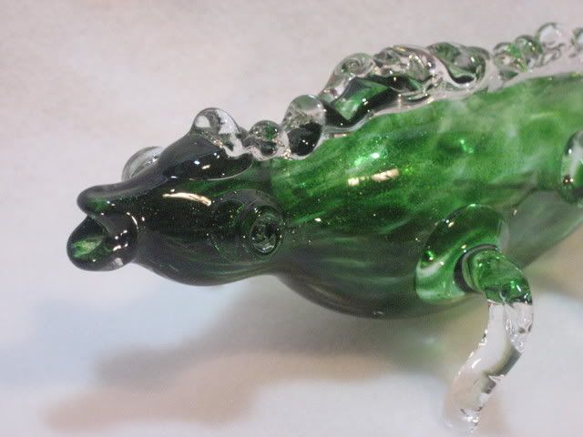 face of green glass monster with googly eyes