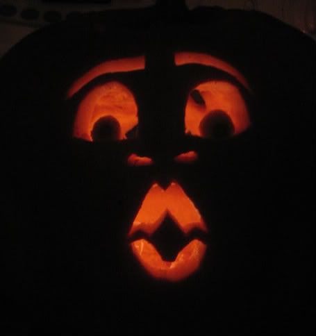 backlit pumpkin with astonished face