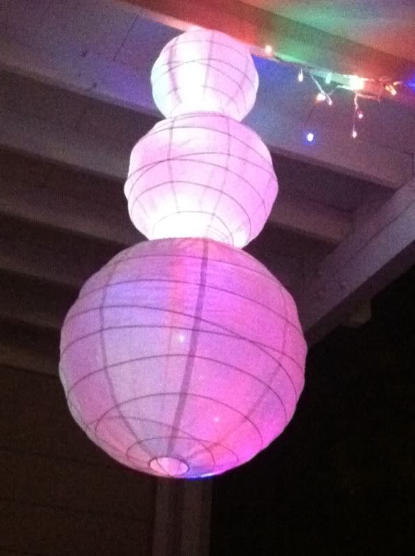 Hanging lit up Snowman made of 3 Japanese paper lanterns, slightly lower view direction